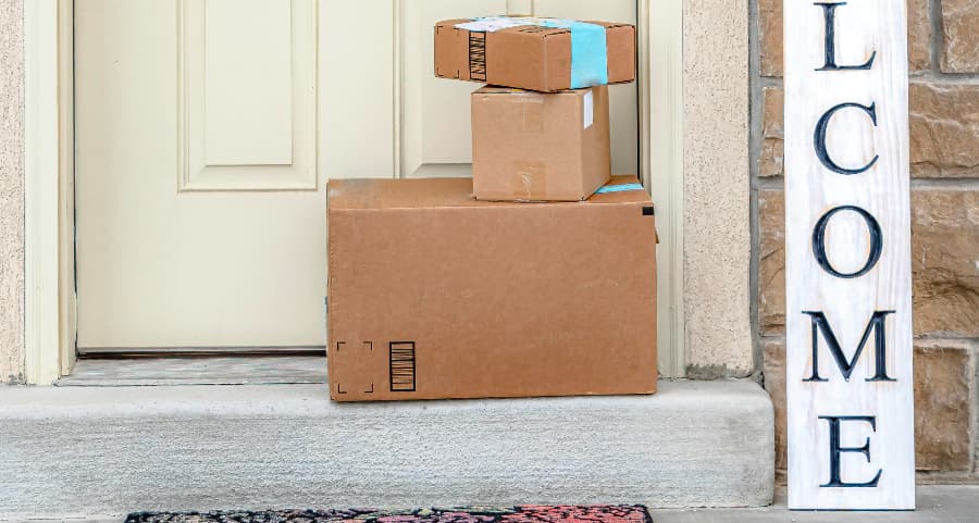 Packages on the doorstep of a home with a welcome sign in Memphis